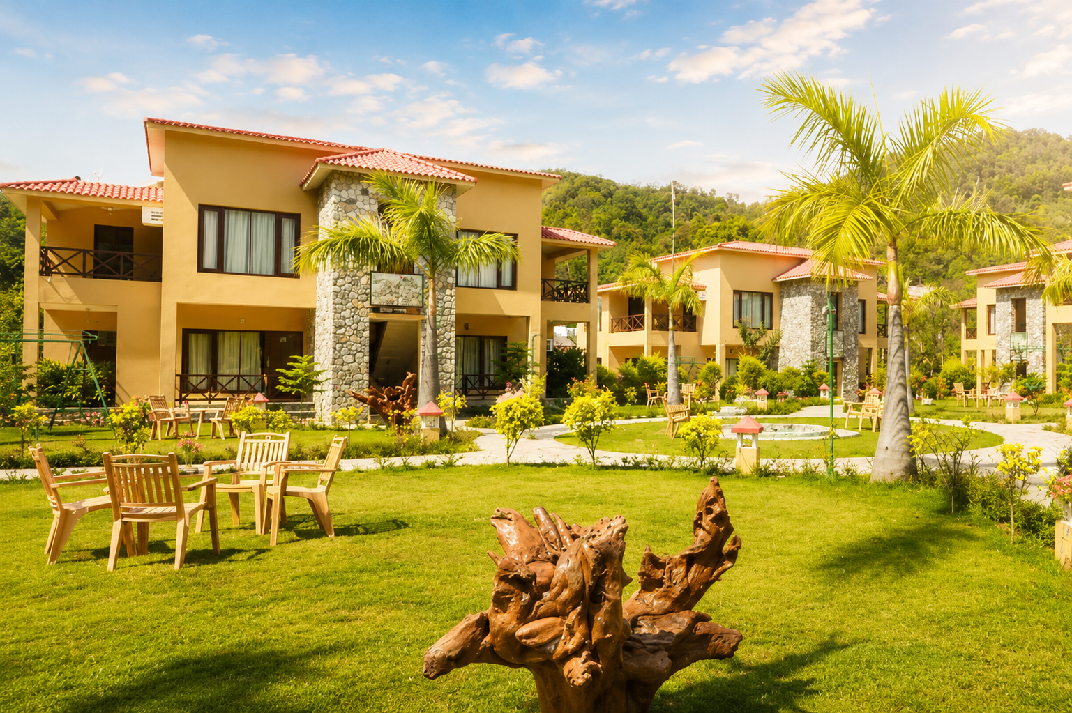 Cottages and lawns at Mango Bloom River Resort in Jim Corbett